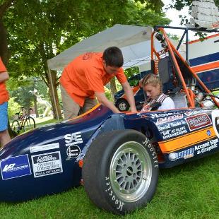 A member of Hope Motorsports helps a student test drive during the Activities Fair