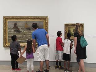 CASA and Hope College students examining artwork in the Kruizenga Art Museum gallery space.