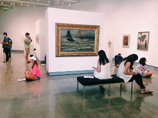 Hope College students studying artwork and working on an assignment in the Kruizenga Art Museum gallery space.