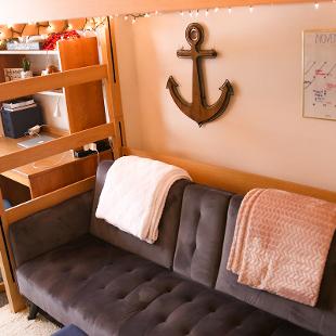 A student room in Kollen Hall showing a couch under the lofted bed.