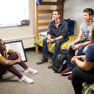 Students in a student room with bunk beds.