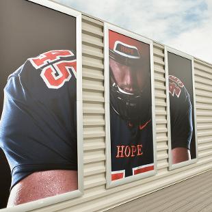 The open sky deck features A three-panel photo display showcasing a a student in his football gear.