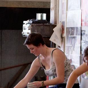 Two female students doing pottery work