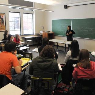 Students listen to a professor in a classroom of Lubbers Hall