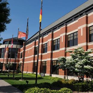 International flags fly outside the Martha Miller Center